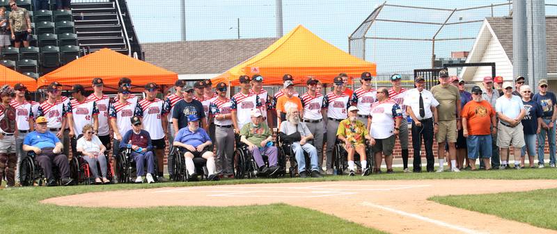 Members of the Illinois Valley Pistol Shrimp baseball team pose with Veterans on Wednesday, July 3, 2024 in Schweickert Stadium at Veterans Park in Peru. The Pistol Shrimp held their annual Salute to Veterans honoring local members who served in the military.