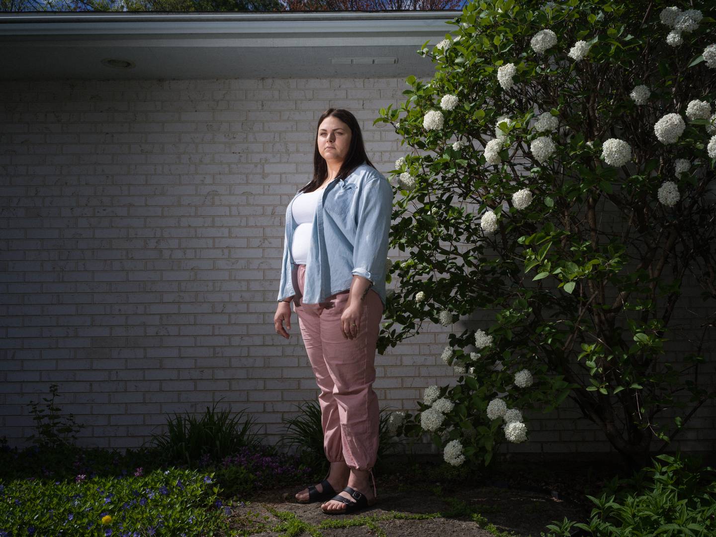 Ashley Holst stands outside her home on April 23, 2024.