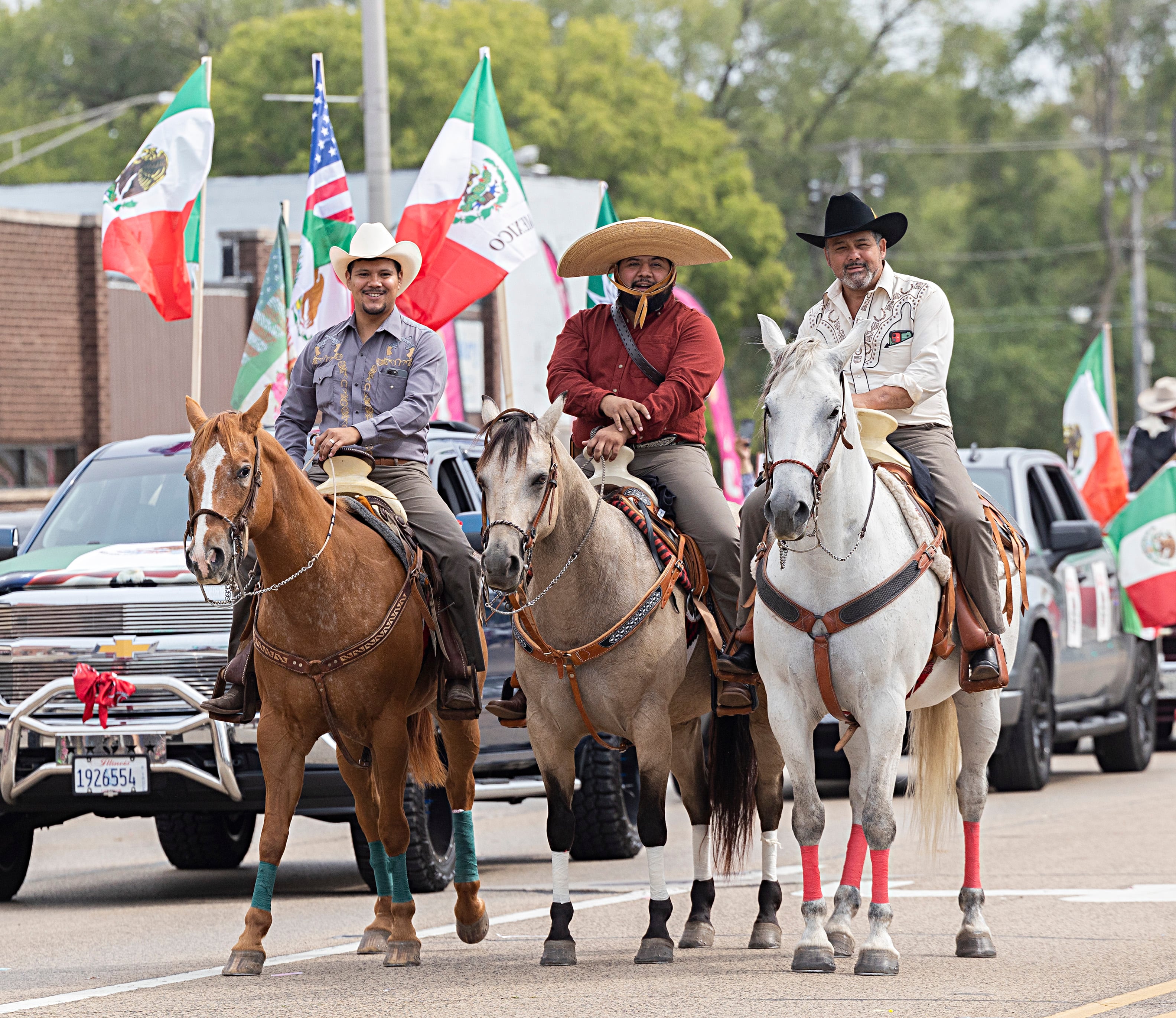 Vaqueros pose for pictures from atop their horses Saturday, Sept. 16, 2023 during the Sauk Valley Fiesta Days parade.