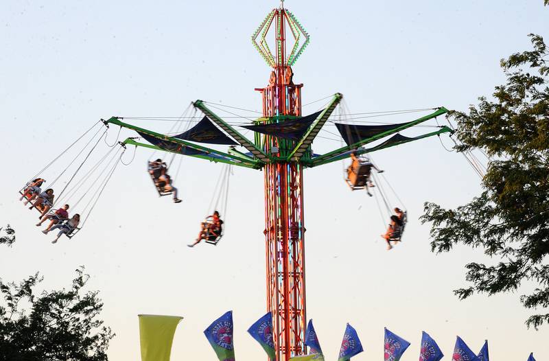 Fair goers soar above the park on the Sky Rider during the Oswegoland Park District's PrairieFest on Friday, June 14, 2024.