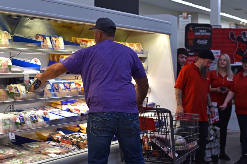 Hometown Hero grand prize winner Matt Ramer shops in the meat section during his two-minute Peru HyVee shopping spree.