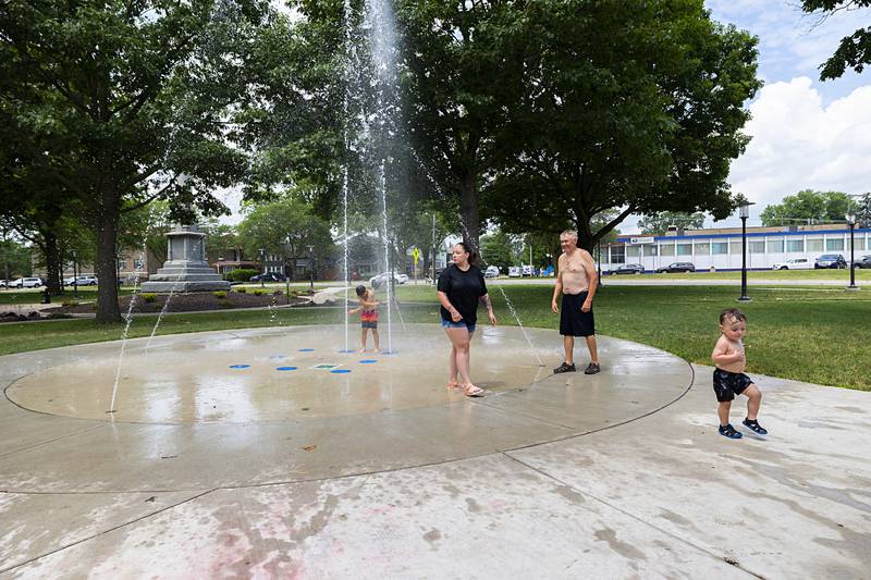 Groups of people stay cool Thursday, June 20, 2024 at the splash pad at Grandon Park in Sterling. Temps will remain in the low 90’s for the next couple days.