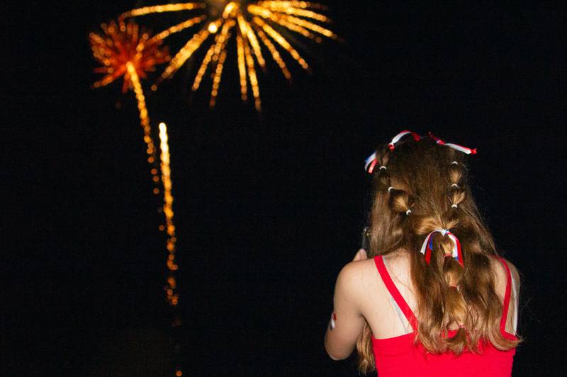 Allison Power takes photo of firework display on her phone on Thursday, July 4, 2024 at Ottawa High School.