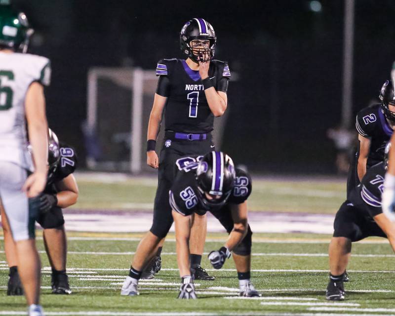 Downers Grove North's Owen Lansu (1) looks over the defense during a football game between Glenbard West at Downers Grove North on Friday, Sept 13th, 2024  in Downers Grove.