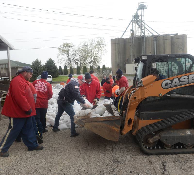 Savanna firefighter Gene Gonyier and inmates from Kewanee were busy placing sandbags behind the downtown business district on Saturday as Mississippi River levels continued to rise. The river was expected to crest at 22' later this week. Flood stage is 16'. The 2019 flood reached 21'.