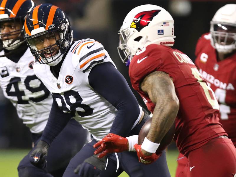 Chicago Bears defensive end Montez Sweat looks to tackle Arizona Cardinals running back James Conner during their game Sunday, Dec. 24, 2023, at Soldier Field in Chicago.
