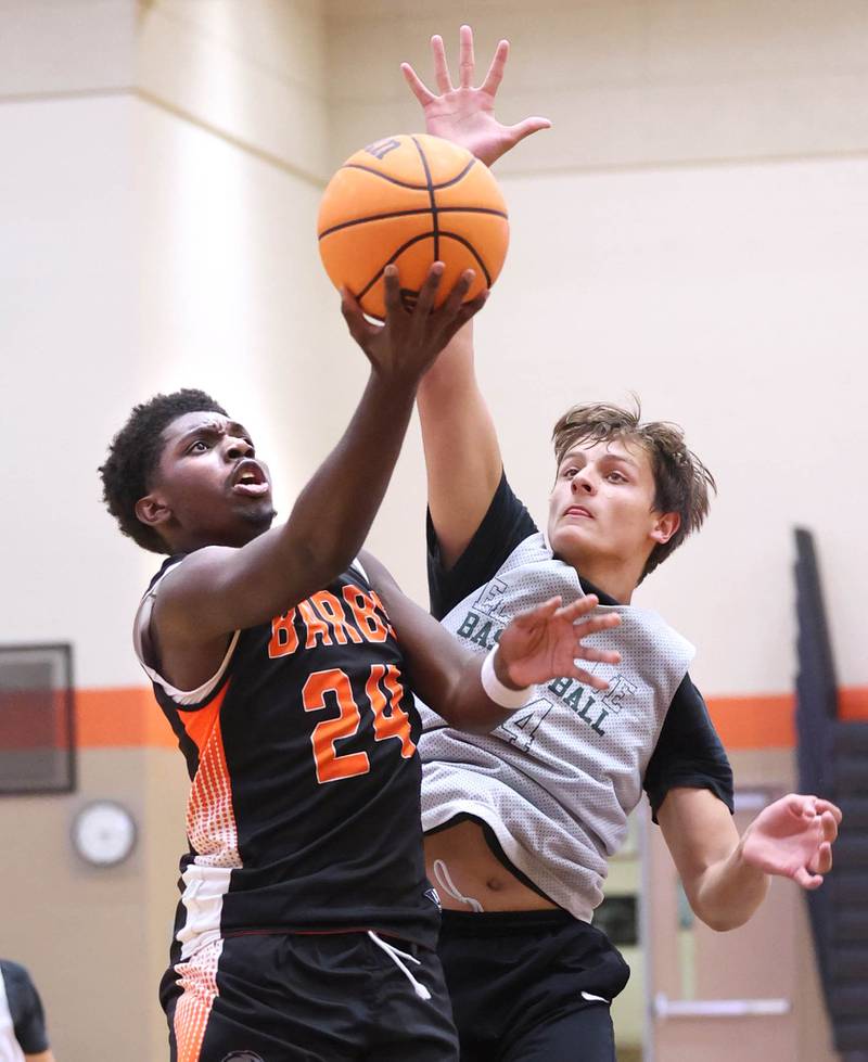 DeKalb’s Myles Newman scores in front of a defender during their summer game against Elk Grove Tuesday, June 18, 2024, at DeKalb High School.