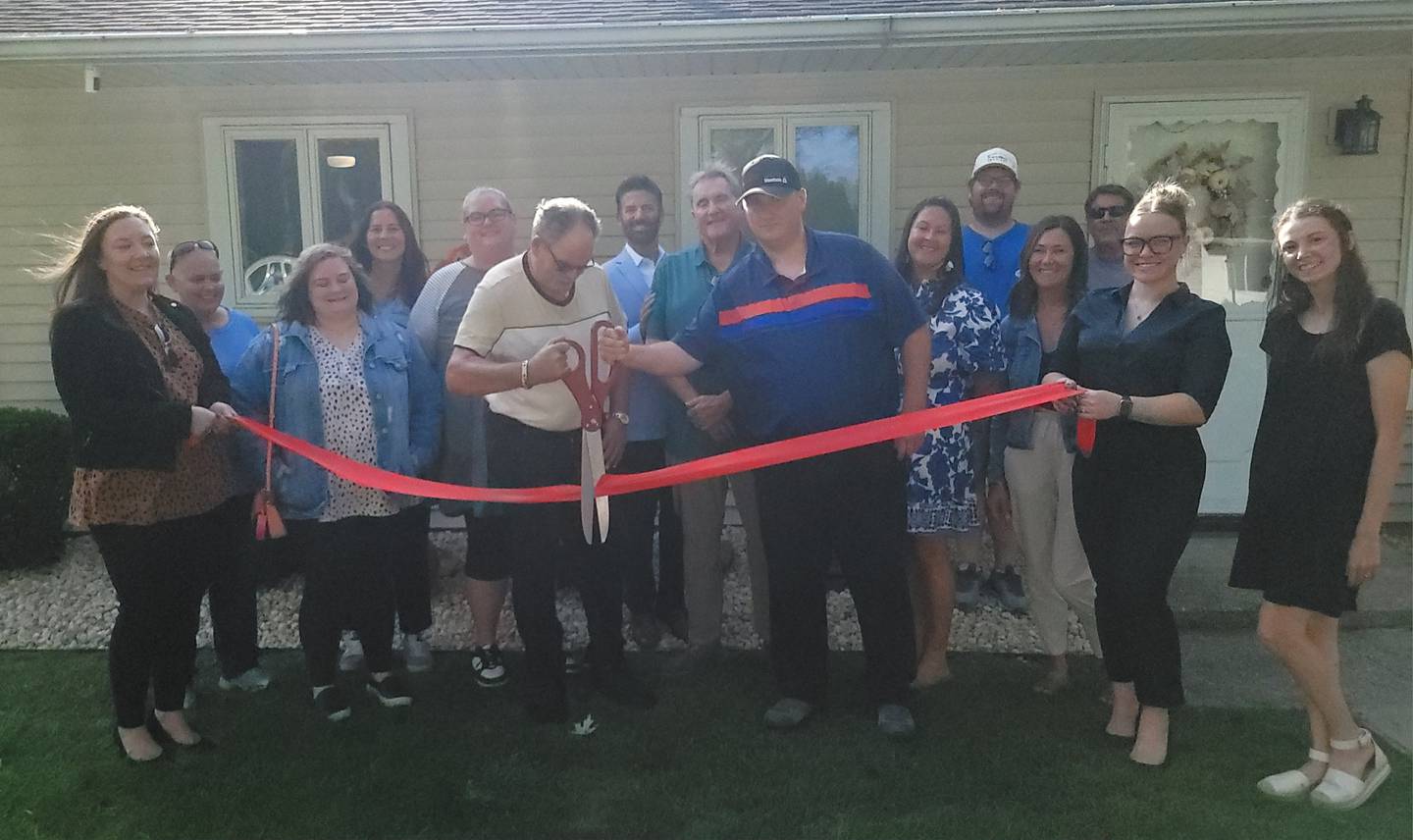 Ottawa Friendship House staff and local dignitaries cut a ceremonial ribbon Thursday, Sept. 12, 2024, on a newly remodeled home in Ottawa. The home will serve as home to three men living semi-independently.