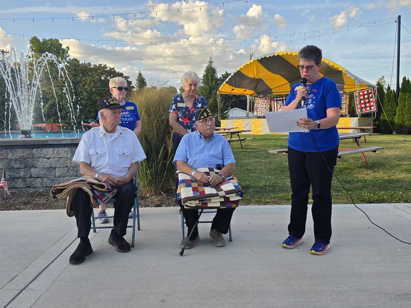 Terry Johnson talks about the military service of Leonard Wayne Lance (left) and Dominic Rivara on Sunday, Sept. 15, 2024, after the two veterans received Quilts of Valor at Senica Square in Oglesby.