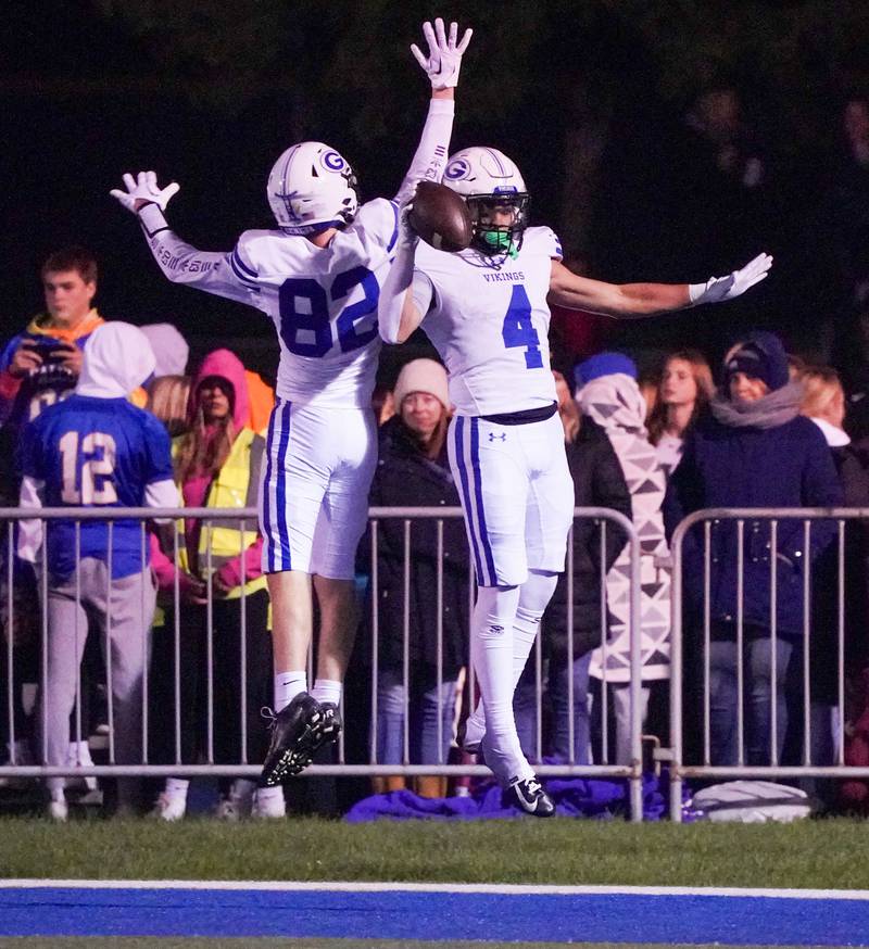 Geneva’s Troy Velez (4) celebrates with Benjamin Perillo (82) after scoring a touchdown against Wheaton North during a football game at Wheaton North High School on Friday, Oct. 6, 2023.