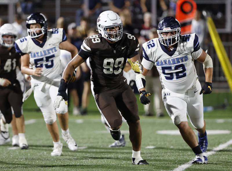 Mt. Carmel's Braeden Jones (99) chases down the quarterback during the varsity football game between Nazareth Academy and Mt. Carmel high school on Friday, Sep. 13, 2024 in Chicago.