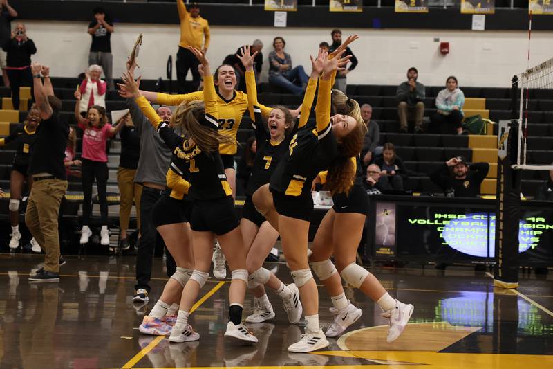 The Joliet West volleyball team celebrates its three-set win over Lockport in the Class 4A Andrew Regional title match on Thursday, Oct. 27, 2022.