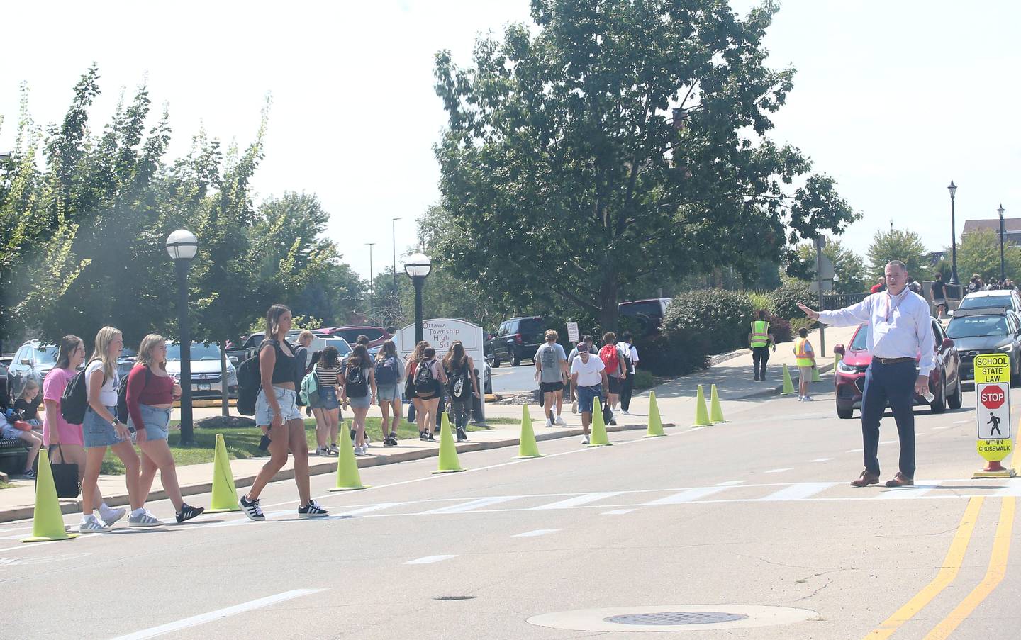 Ottawa High School superintendent Dr. Michael Cushing, (right) directs traffic on the first day of school on Thursday, Aug. 8, 2024.