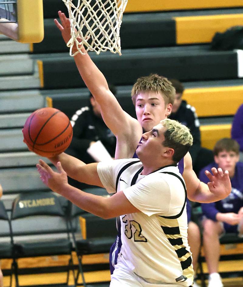 Sycamore's Diego Garcia goes to the basket against Rochelle's Eli Luxton during their game Tuesday, Dec. 5, 2023, at Sycamore High School.