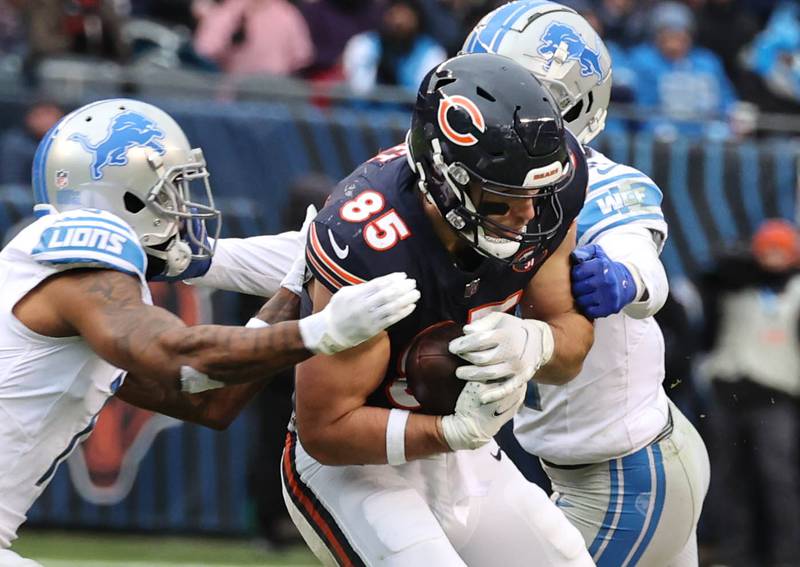 Chicago Bears tight end Cole Kmet catches a pass between two Detroit Lions defenders during their game Sunday, Dec. 10, 2023 at Soldier Field in Chicago.