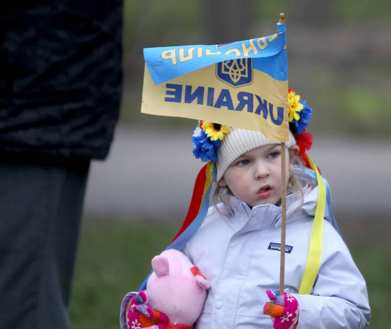 Three-year-old Clara McDonald of Hinsdale attends a vigil with her mother and sister in support of the people of Ukraine at Wilder Park in Elmhurst on Wednesday, April 6, 2022. The event was organized by the City of Elmhurst, Elmhurst District 205, Elmhurst Park District, Elmhurst Public Library and Elmhurst University.