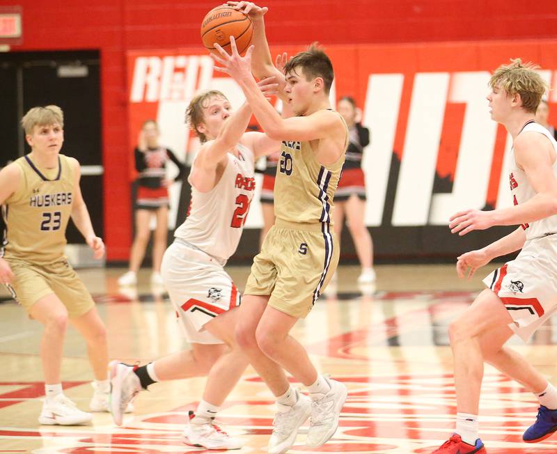 Serena's Beau Raikes hangs on to the ball as Earlville's Griffin Cook draws a foul on Friday, Feb. 9, 2024 at Earlville High School.