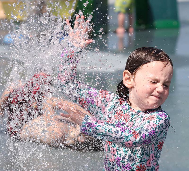 Scarlett Thunder, 4, from Sycamore, runs through the sprinklers Tuesday, June 14, 2022, at the Sycamore Park District’s Splash Fountain. Temperatures reached nearly 100 degrees Tuesday and highs are expected to remain in the 90's through Thursday.