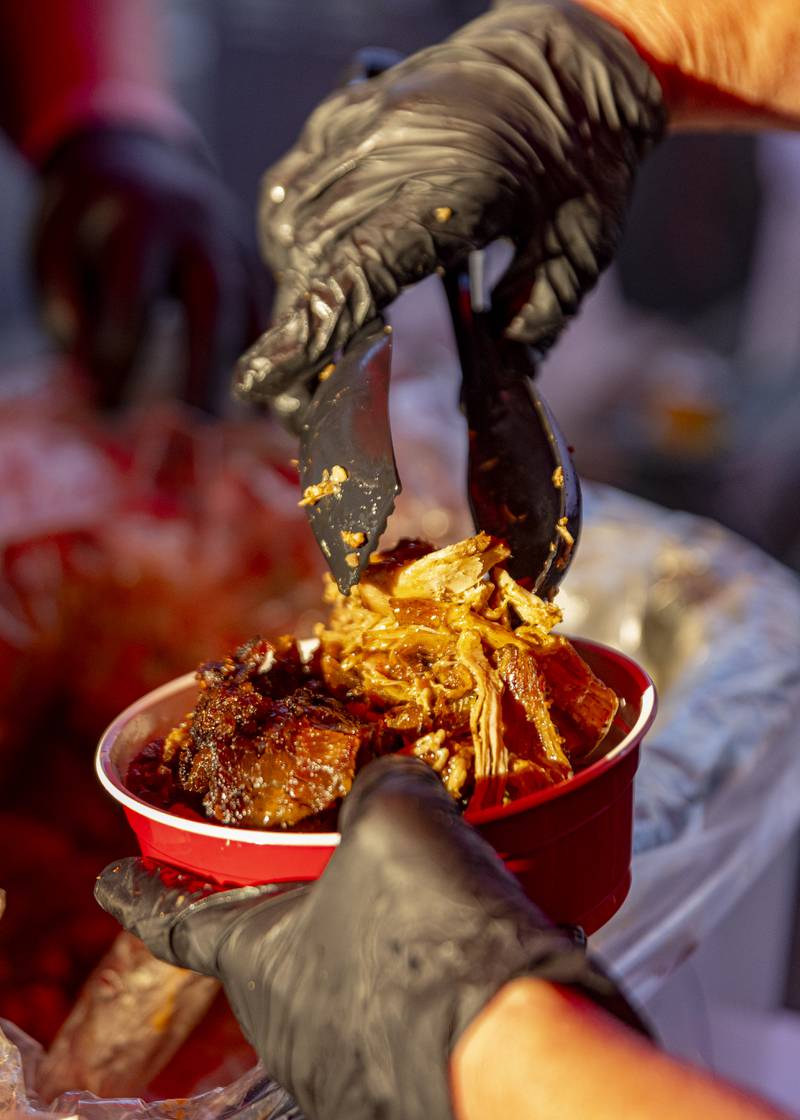 Fresh, homemade pulled pork from Francis St. BBQ is placed into a sampler bowl Sunday, May 26, 2024, at the Music and Arts Festival at Pulaski Park in La Salle.