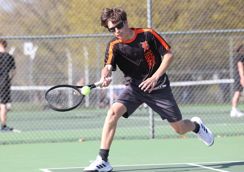 DeKalb number two singles player Charlie Vander Bleek reaches to hit a forehand Wednesday, April 26, 2023, during their match at Sycamore High School.