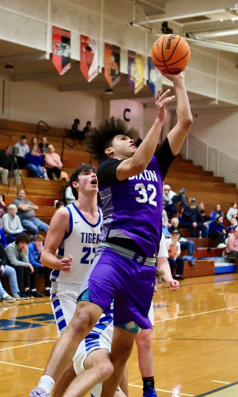 Dixon's Darius Harrington runs the baseline for a third-quarter basketball Monday night at Princeton. He scored 36 points to lead the Dukes to a 61-50 victory.