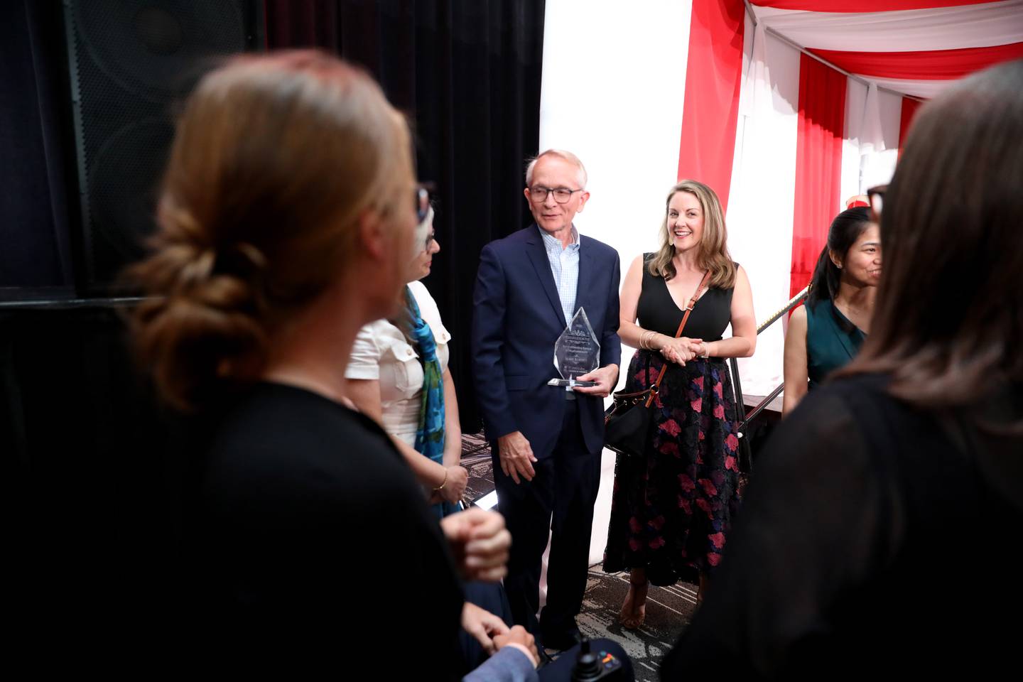 Mark Koenen (center), 2024 Charlemagne Award winner, is surrounded by his family during the 56th Annual Charlemagne Awards Dinner hosted by the St. Charles Chamber of Commerce at the Q Center in St. Charles on Friday, May 17, 2024.