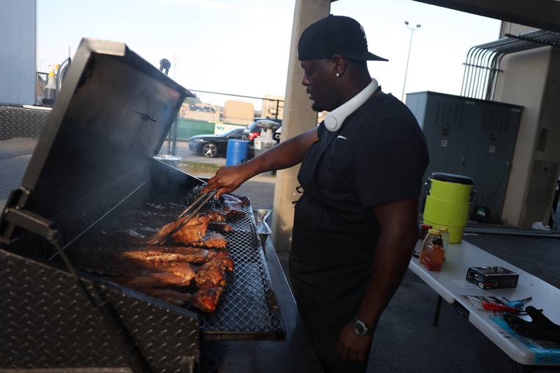 Mercedes Brown works the smoker at the ELC Cooking from the Soul food tent at the Taste of Joliet on Friday, June 21, 2024 at Joliet Memorial Stadium.