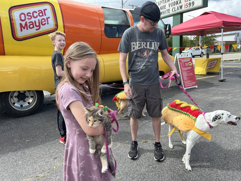 Robert Graham of Morrison brought his two pups, Penny and Ashes, while Jacqualynn Graham, 7, also of Morrison, brought her calico kitten, PJ to see the Wienermobile on Friday, Sept. 6, 2024 at Sullivan's Foods in Morrison.