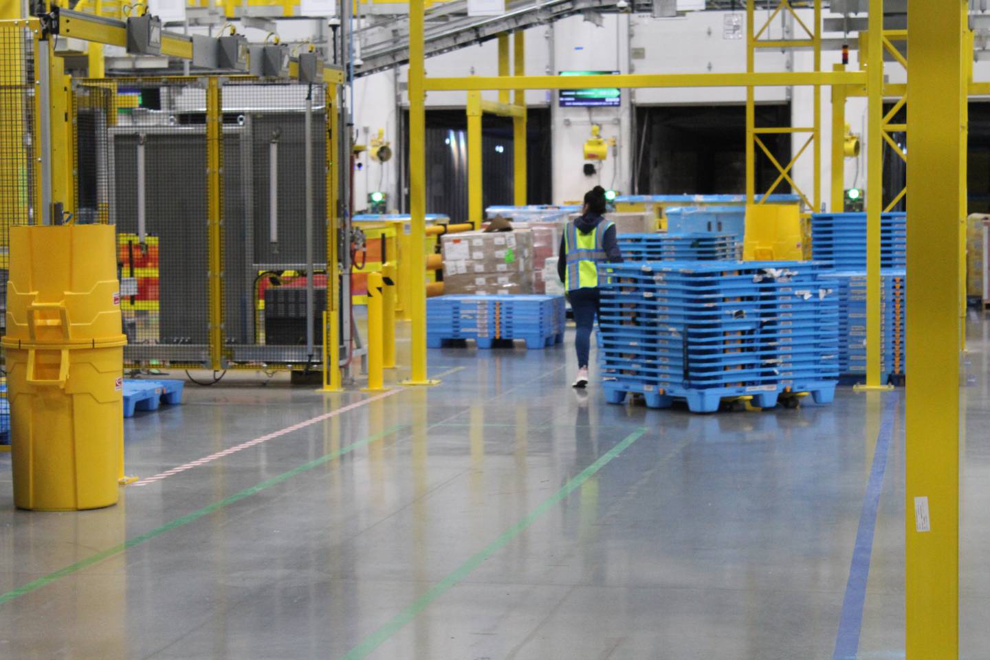 An Amazon employee moves pallets at the new Huntley warehouse.