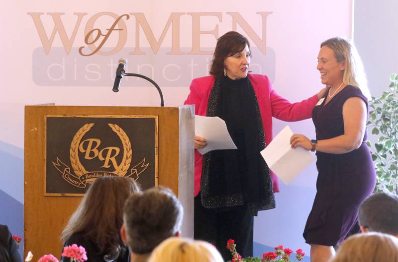 Kathleen Caldwell greets award recipient Sarah Hagen as she walks to the stage during the Northwest Herald's Women of Distinction award luncheon Wednesday June 5, 2024, at Boulder Ridge Country Club, in Lake in the Hills. The luncheon recognized 11 women in the community as Women of Distinction.