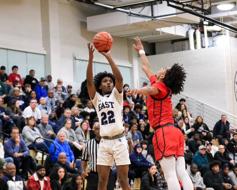 Oswego East's Javion Starwood (22) shoots a jump shot during Class 4A Lockport Regional final game between West Aurora at Oswego East.  Feb 24, 2023.