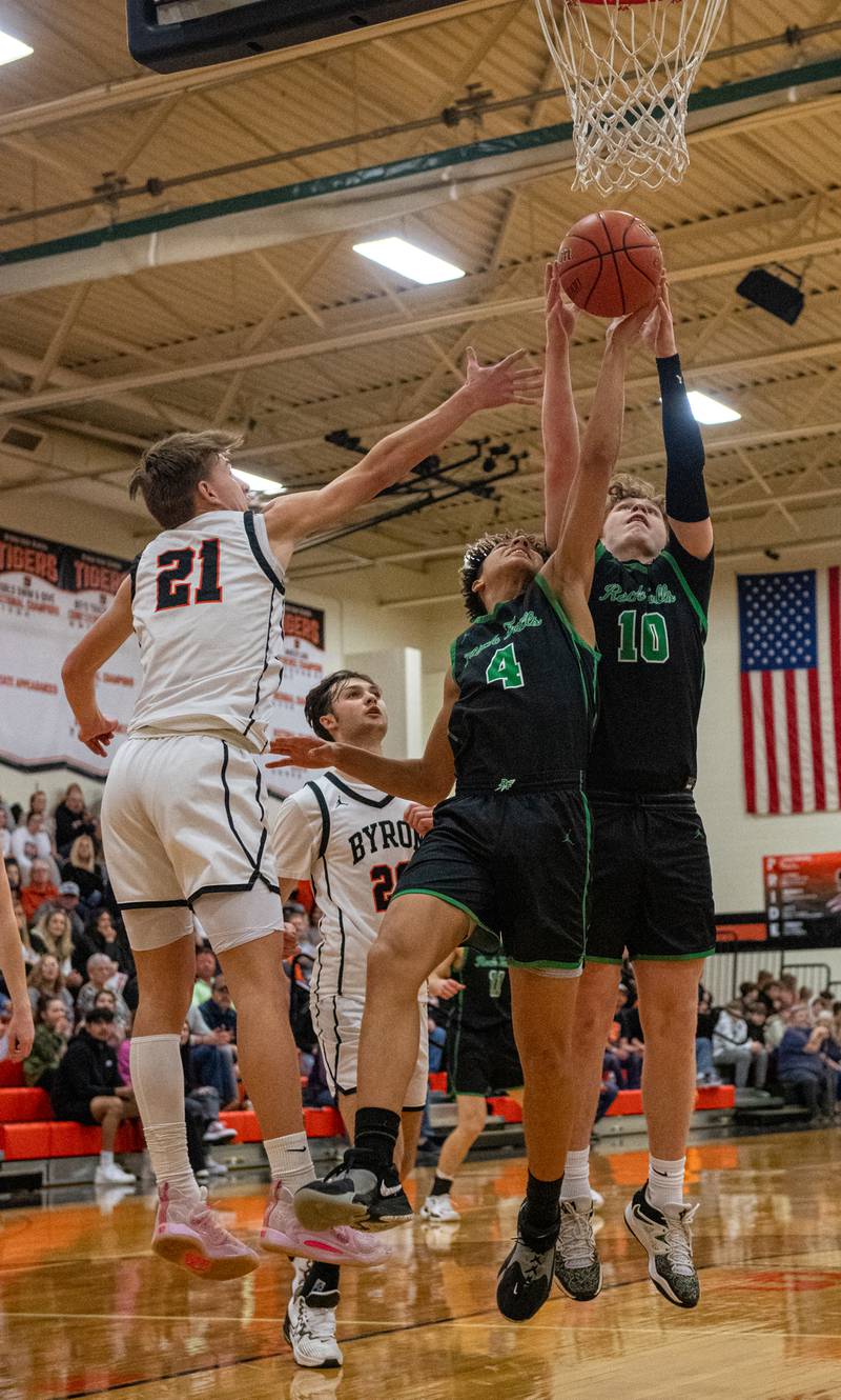 Rock Falls' Devin Tanton (4) and Kuitim Heald (10) grab a rebound against Byron's Cason Newton during the second quarter of the 2A Byron Regional championship game on Saturday, Feb. 25, 2023.