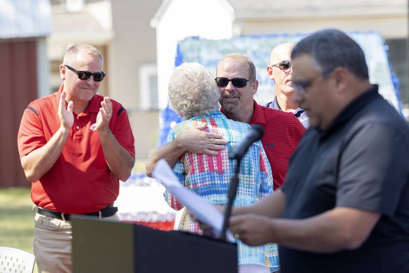 Dixon Park District Director Duane Long hugs Louise Reed Tuesday, Sept. 17, 2024, after her speech at the basketball courts' dedication.