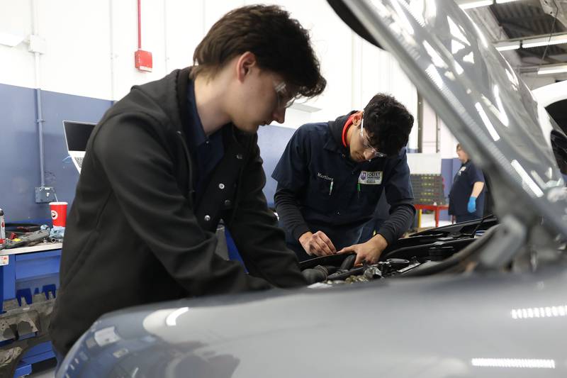 Thomas Cipiti (left) and Adrian Martinez finish up working on an engine during Auto Service IV class at Joliet Junior College on Thursday, Feb. 1, 2024.