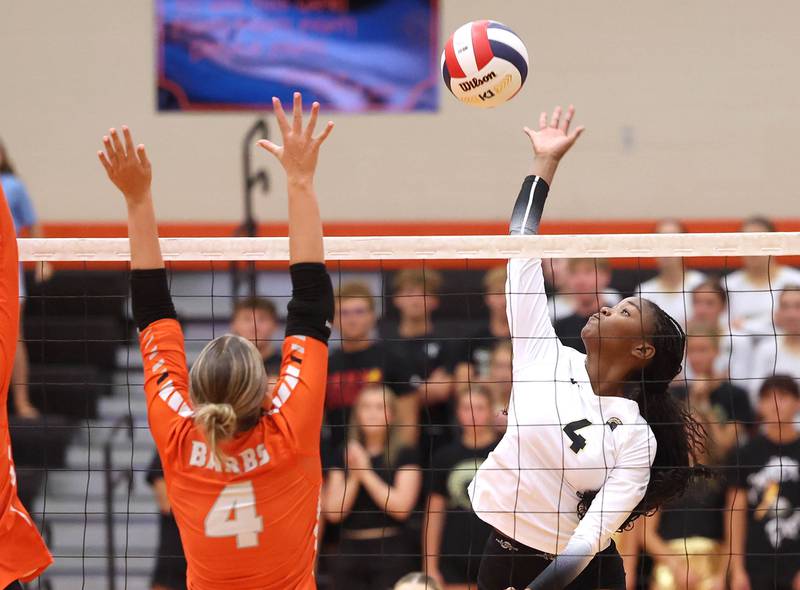 Sycamore's Khiara Thomas tries to spike the ball by DeKalb's Maddi Hollar during their match Wednesday, Aug. 28, 2024, at DeKalb High School.