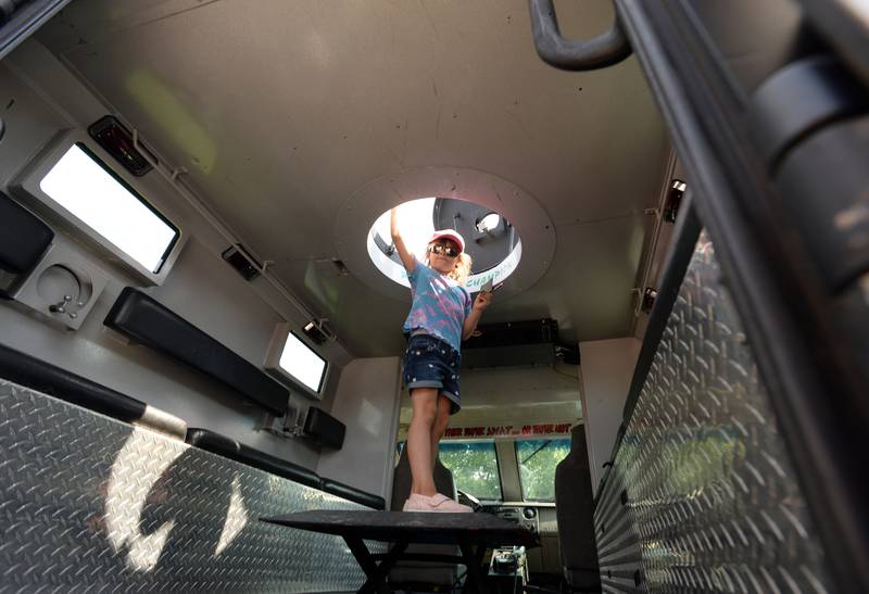 Children including Eleanor Webb of Lombard take a look inside an Armored Avenger during the First Responders event held at Brookfield Zoo Sunday Aug 28, 2022.