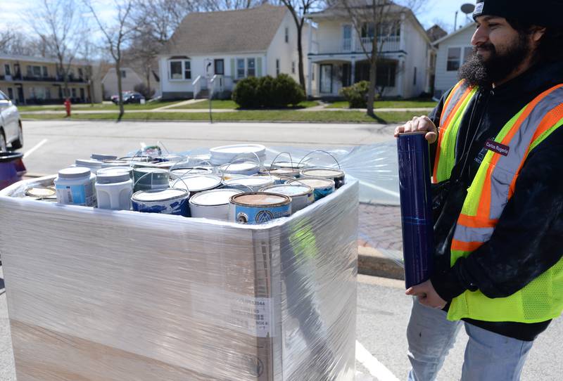 Flat Can Regional Manager Recycling Assistant Carlos Rugerio wraps used paint cans during the Electronics and More Recycling event held in Westmont Saturday, April 6, 2024.