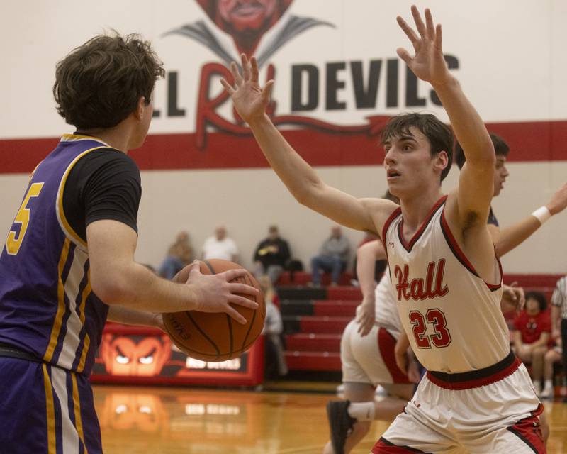 Hall's Braden Curran attempts to block the pass of Mendota's Cameron Kelly during the IHSA 2A semifinal game at Hall High School on February 19, 2024.