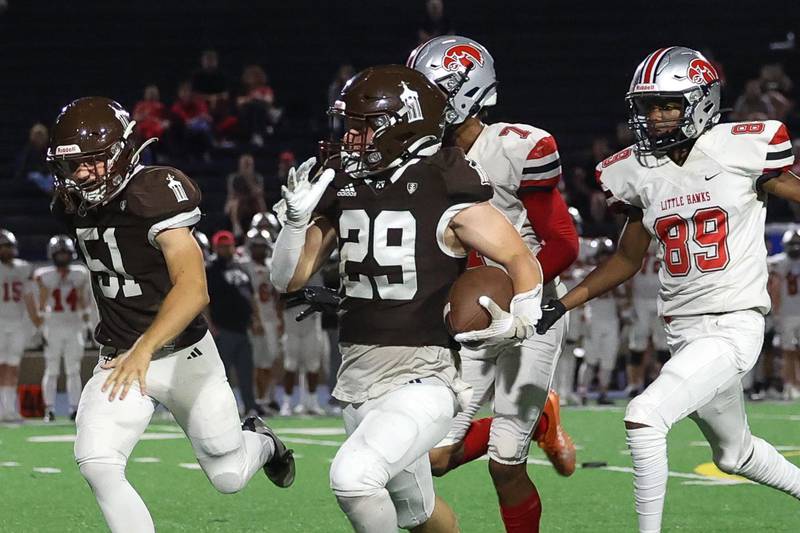 Joliet Catholic’s Keegan Farnaus breaks away for a big gain against Iowa City on Friday, August 30, 2024 in Joliet.