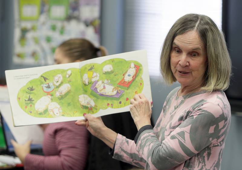 Sharon Lamps, third and fourth grade teacher at Dalzell Grade School, reads a book to her class called "April Foolishness" on Thursday March 31, 2022. Lamps has been teaching for 35 years and currently teaches part time at the school on Tuesdays and Thursdays.