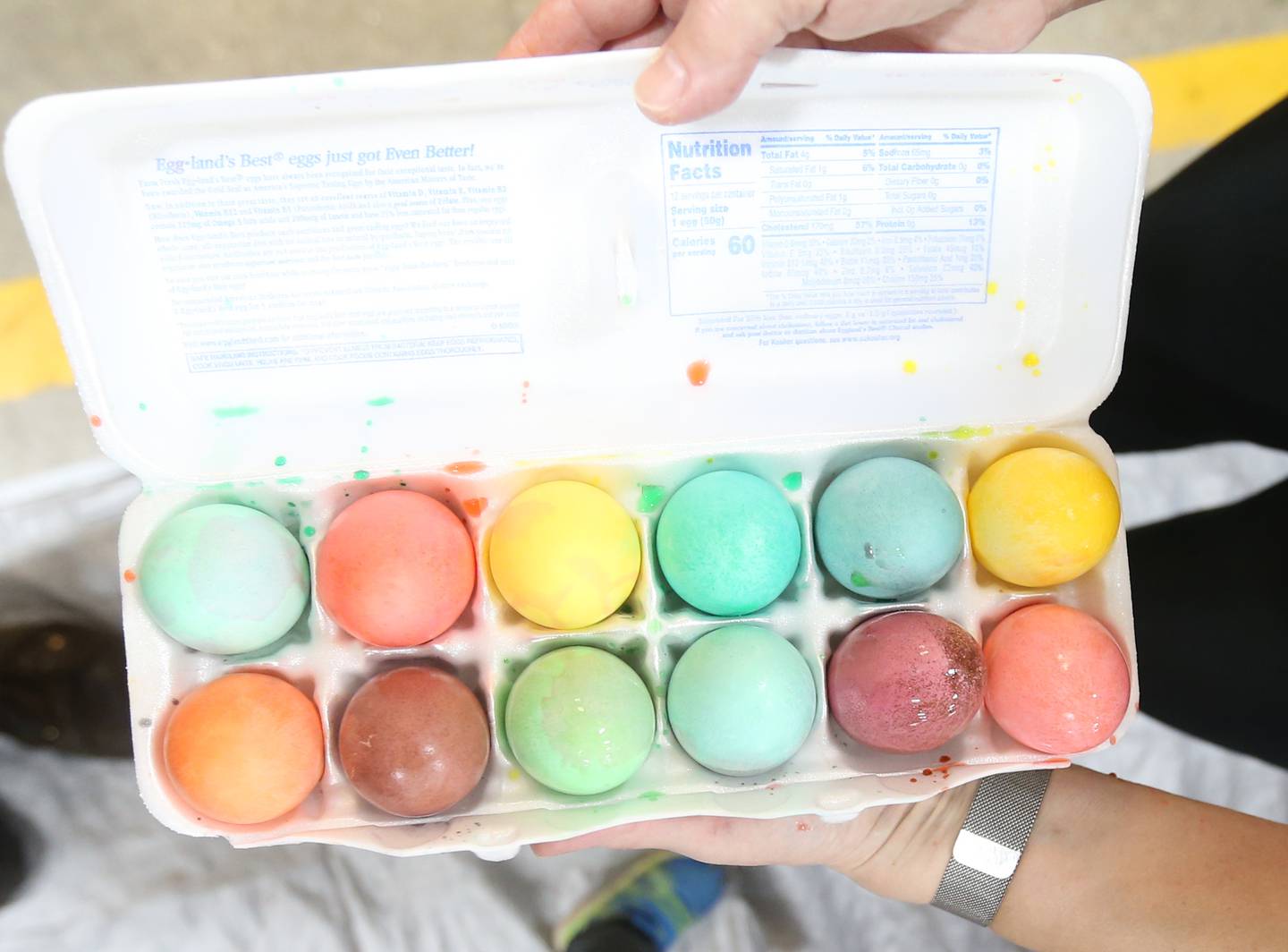 Colorful Easter eggs are put into a container as Utica volunteers and personnel help dye them for the departments annual Easter Egg Hunt on Friday, April 7, 2023 at the Utica Fire Station. The hunt takes place Saturday morning at 11a.m. in Carey Memorial Park in Utica. The Utica Fire Department has hard boiling the eggs for their hunts since the 1970's.