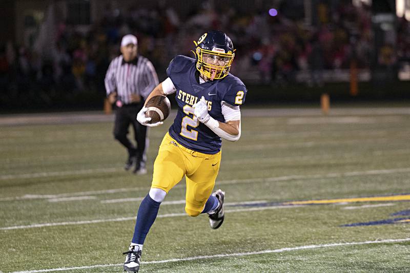 Sterling’s Cale Ledergerber looks for running room against Quincy Friday, Oct.6, 2023 in Sterling.