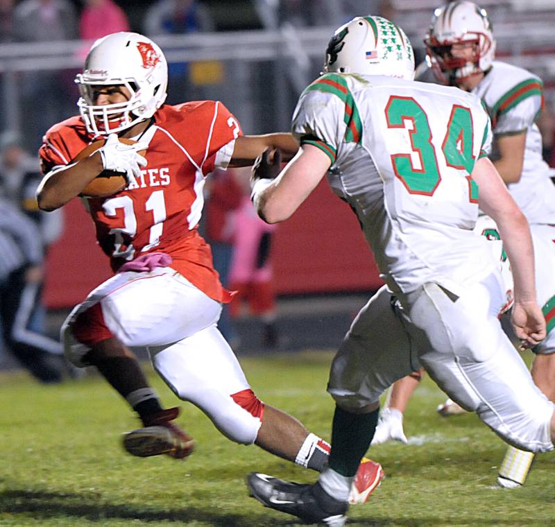 Ottawa's Josh Williams runs up field as La Salle-Peru's Kobey Fusinetti closes in for a tackle during the 2014 game.