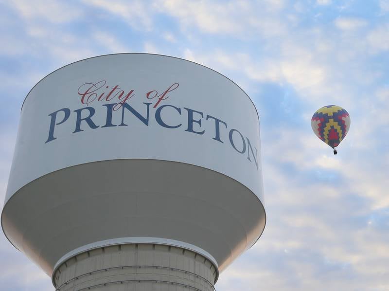 A hot air balloon passes by the City of Princeton water tower on Sunday, Sept. 10, 2023 for the 52nd annual Homestead Festival.