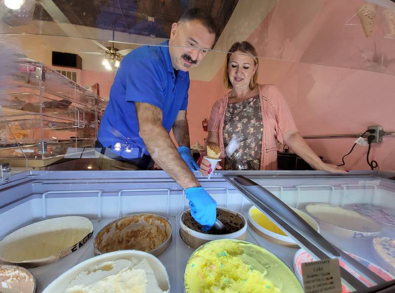 Stephanie and Sam Cato, shown dispensing an ice cream treat for a lucky customer, have opened Hey Sweetie, a candy and ice cream shop located at 203 W. Main St. in Ottawa.