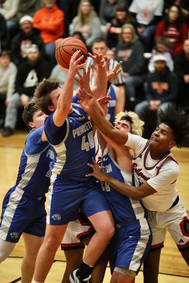 Princeton's Jordan Reinhardt (40) and Noah LaPorte (23) battles Kewanee's Braydon Conley for a rebound Tuesday night at Kewanee. The Tigers fell in overtime 64-59.