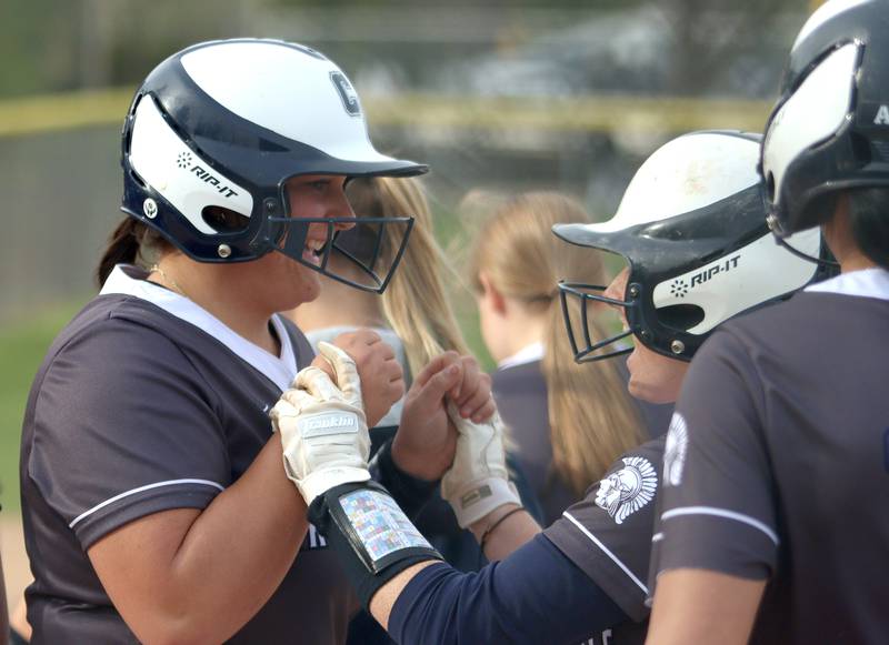 Cary-Grove’s Addison DeSomer is greeted  after a home run against Burlington Central in varsity softball at Cary Monday.