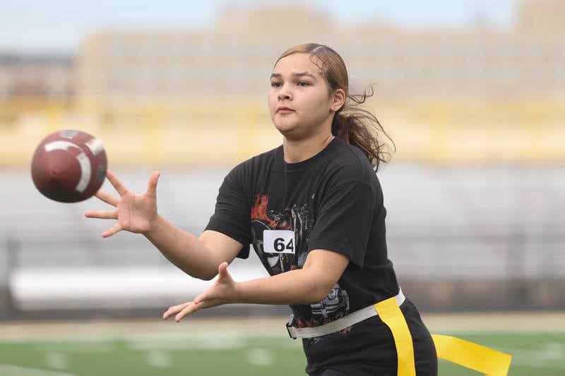 Niyonna Reddington pulls in a pass during Joliet West’s girls flag football tryouts Monday, Aug. 12, 2024  at Joliet West High School.