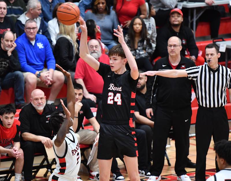 Benet's Daniel Pauliukonis (24) passes over Bolingbrook's DJ Strong during a Class 4A East Aurora Sectional semifinal game on Feb. 27, 2024 at East Aurora High School in Aurora.