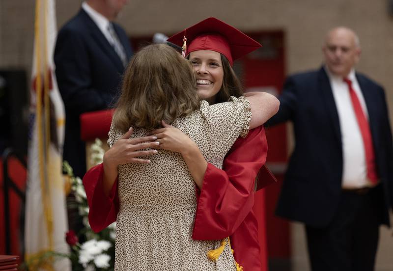 Rylee O'Fallon receives her diploma and a hug from Tracey O'Fallon, her mother and Ottawa High School faculty member, on Friday, May 24, 2024, at Kingman Gym.